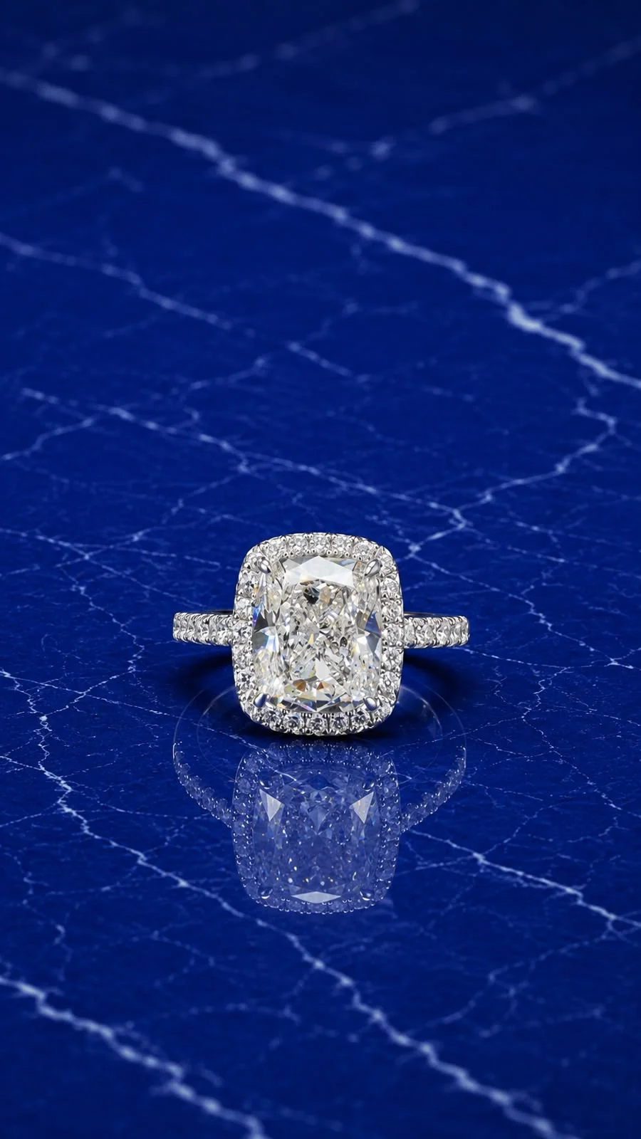 Cushion halo engagement ring with a cushion-cut lab grown diamond center and diamond halo