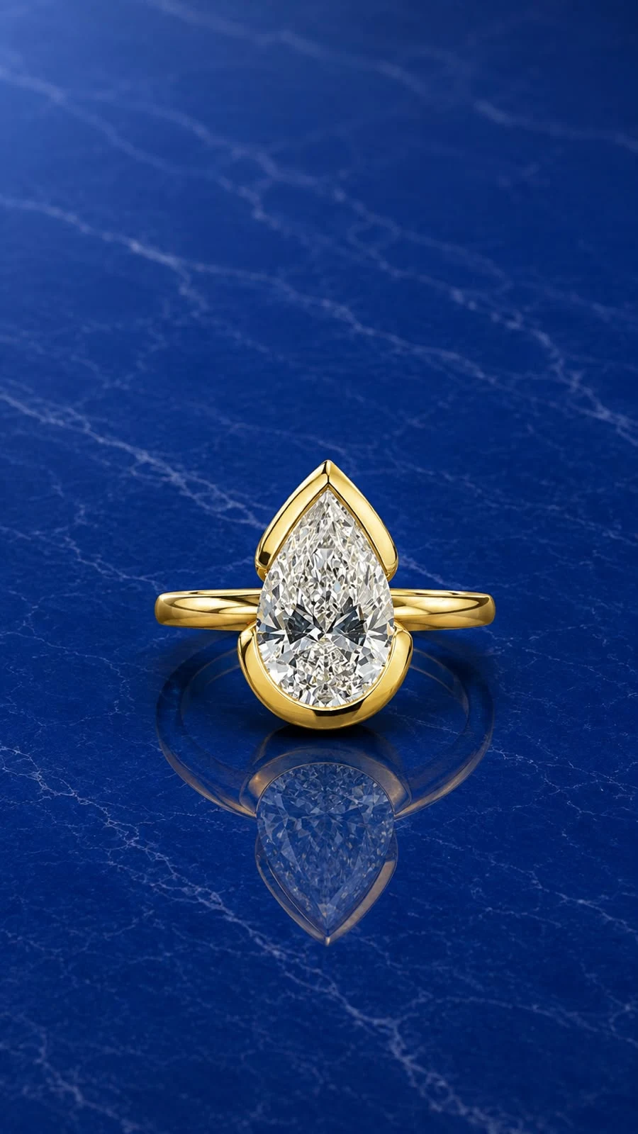 Pear half bezel set engagement ring with a pear-cut lab grown diamond center