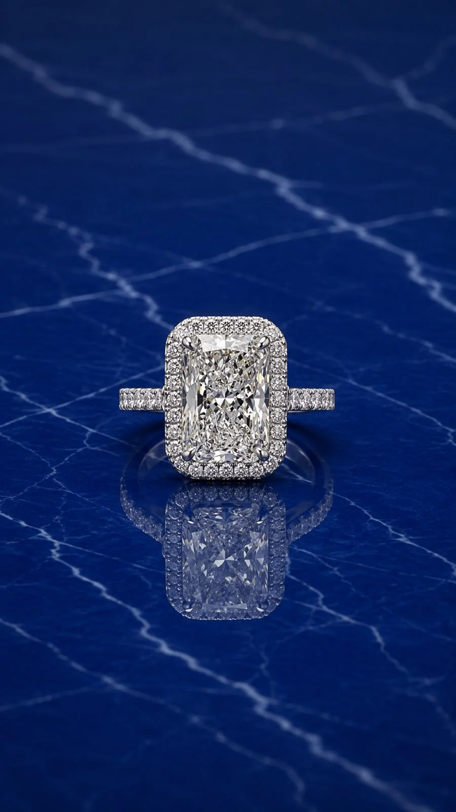 Radiant halo engagement ring with a rectangular-cut lab grown diamond center and diamond halo