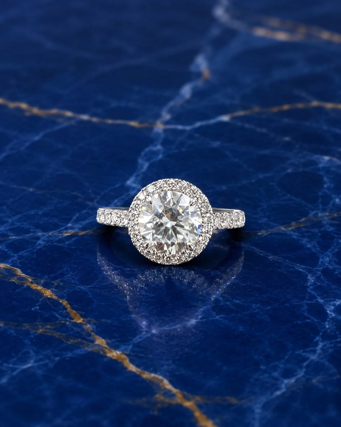 Round halo engagement ring featuring a brilliant-cut lab grown diamond center stone encircled by diamonds